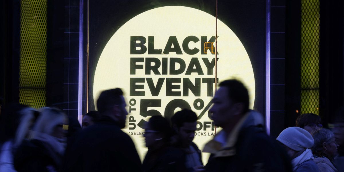 https://www.gbnews.com/media-library/shoppers-walk-past-a-store-window-with-a-sign-promoting-the-black-friday-sales.jpg?id=50555283&width=1200&height=600&coordinates=0%2C390%2C0%2C630