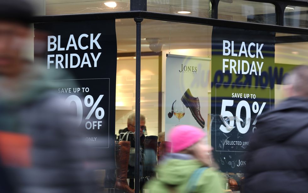 Shops in Canterbury, Kent, displaying offer posters ahead of Black Friday sales. Scam online shopping "bargains" that turned out to be too good to be true cost shoppers 15.4 million over Christmas last year, according to police