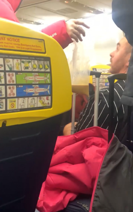Sick bag being held on the plane