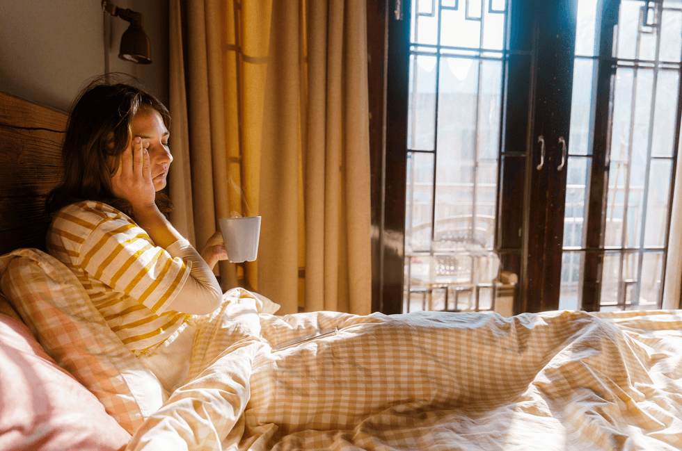Sick woman sits in bed