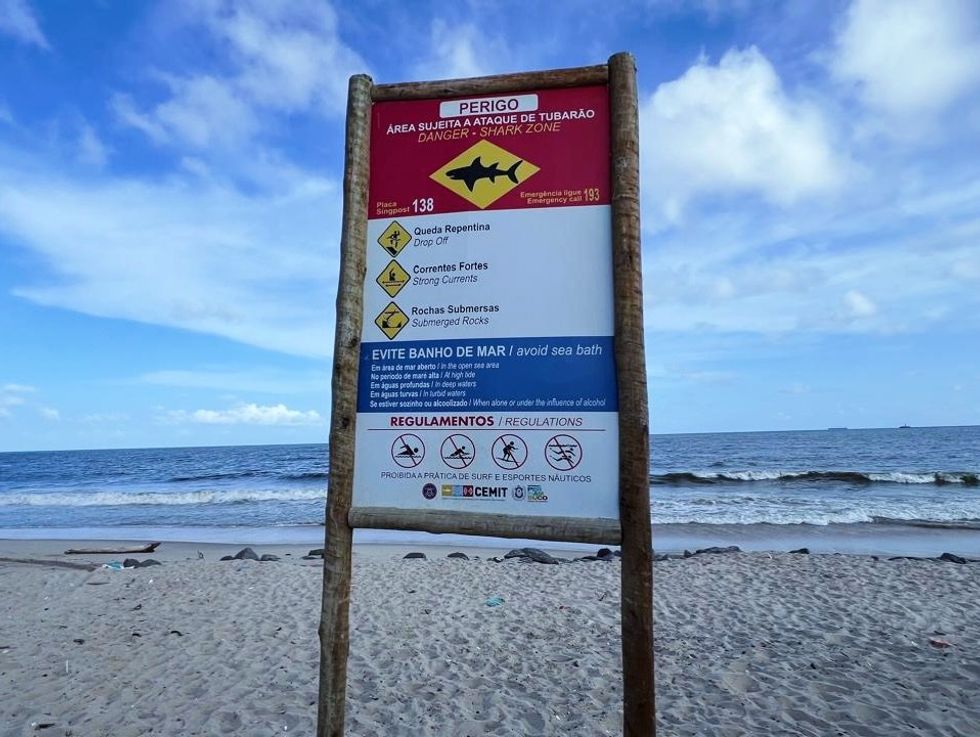 Sign on Brazil beach warning of sharks