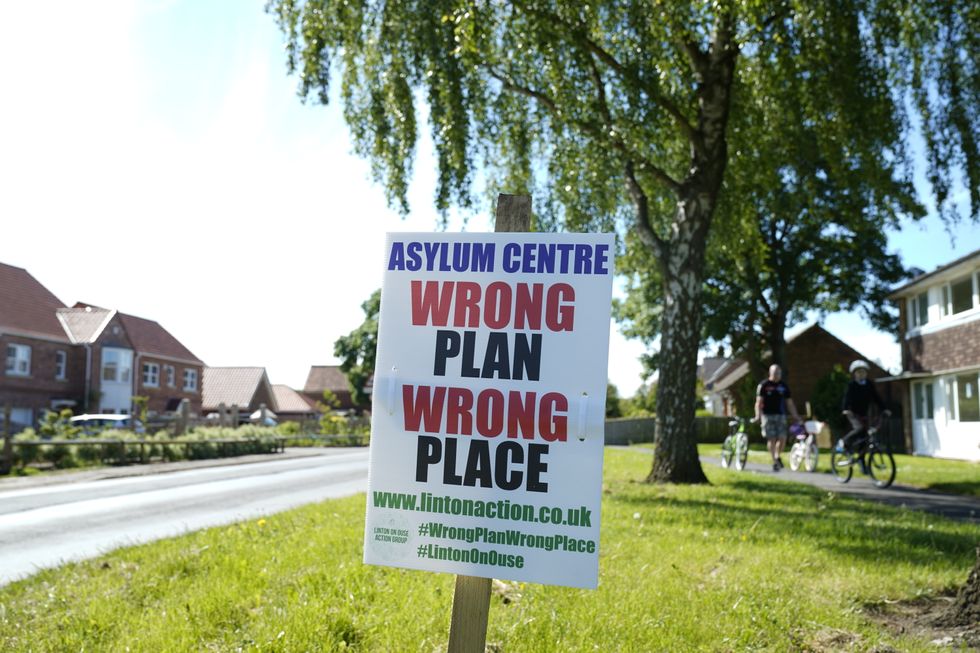 Signs in Linton-on-Ouse Village Hall, North Yorkshire, where members of the parish council are meeting to discuss a Home Office proposed asylum seeker centre at a nearby former RAF base. Picture date: Thursday May 19, 2022.