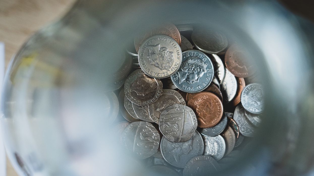 Silver round coins on blue round container