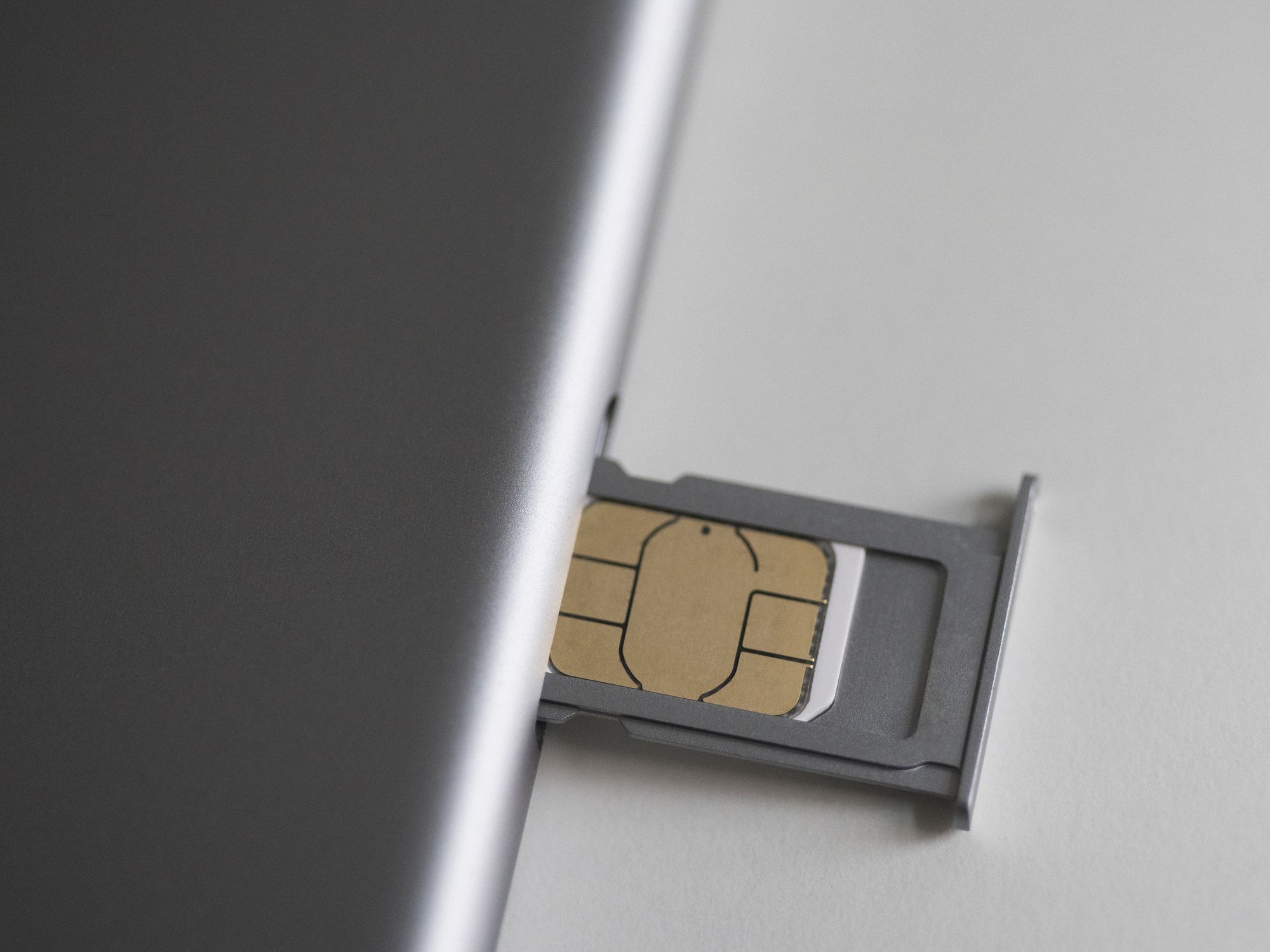 SIM card pictured inside a SIM tray on a smartphone