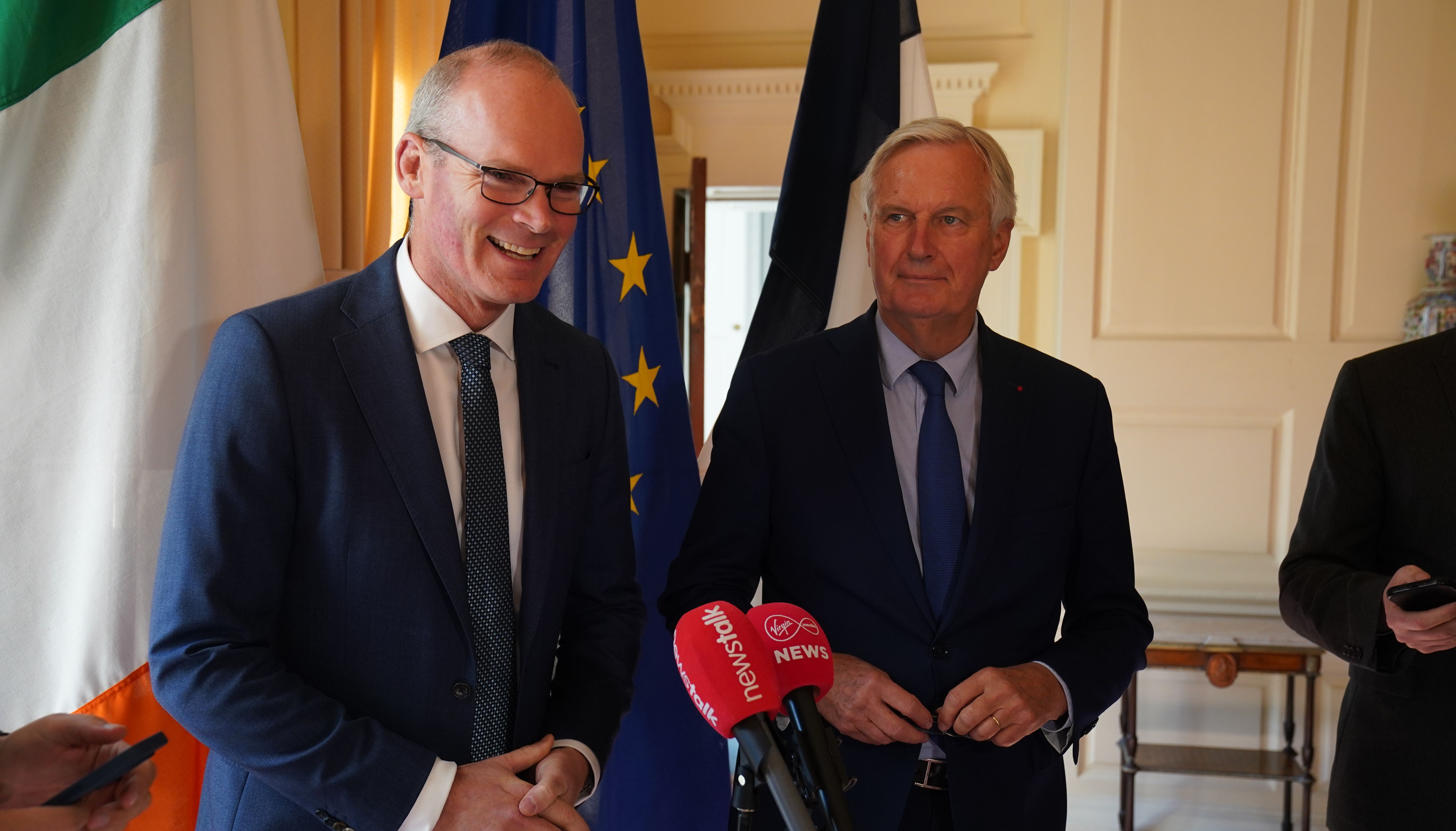 Simon Coveney says he is optimistic that a solution could be found amid increasing international challenges.