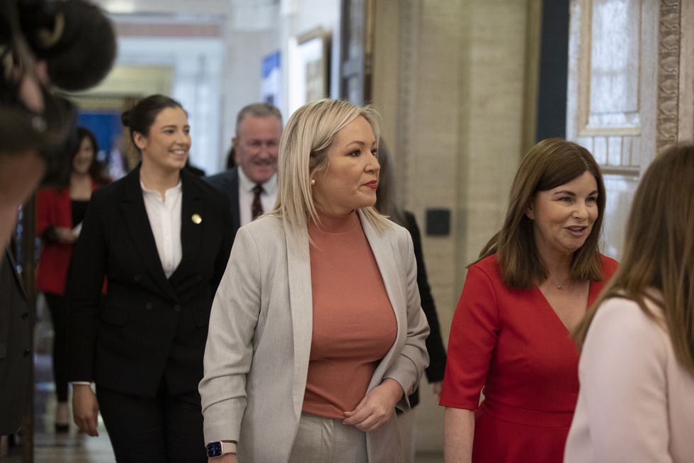 Sinn Fein Vice-President Michelle O'Neill walking out of the Northern Ireland Assembly Chamber with the SDLP's Sinead McLaughlin after signing the Roll of Membership in Parliament Buildings at Stormont.