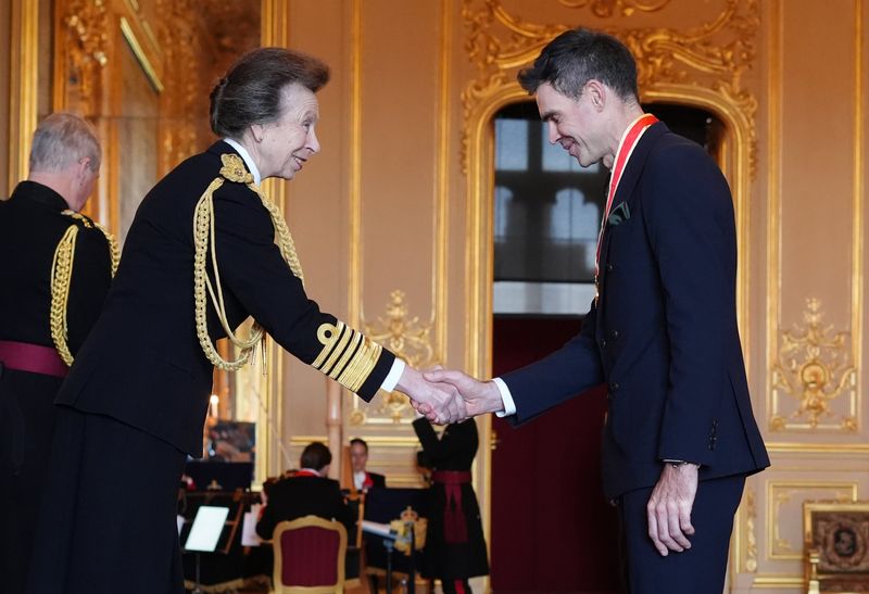 Sir James Anderson shaking hands with Princess Anne