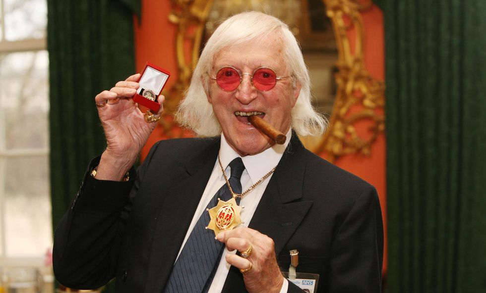 Sir Jimmy Savile after he received a commemorative badge from Prime Minister Gordon Brown at Downing Street in London for his work as a 'Bevin Boy'.