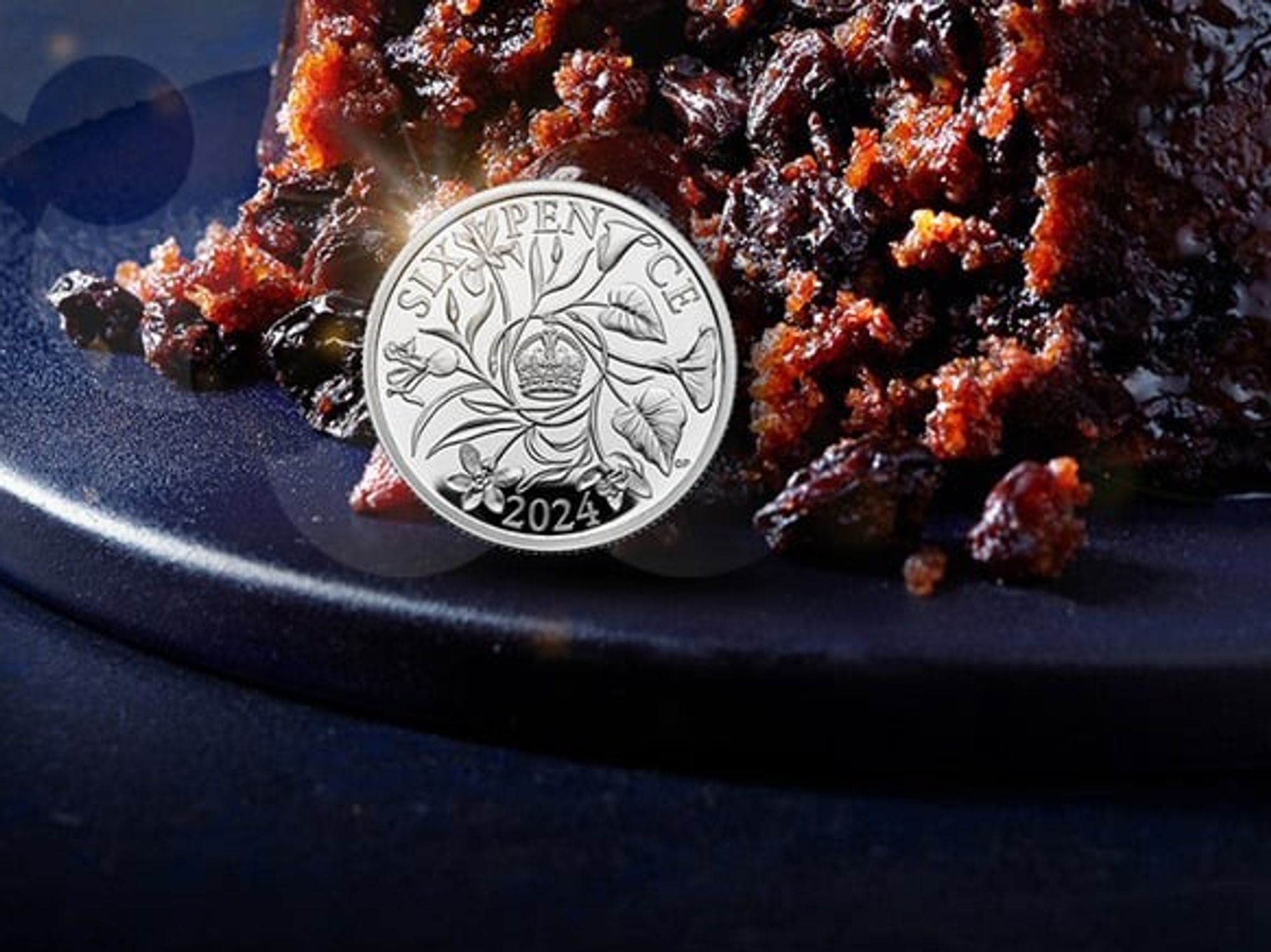 sixpence coin sat next to a Christmas pudding