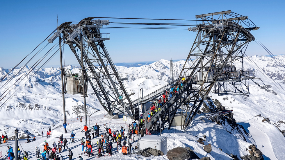 Skiers lining up to ride a gondola at a French resort