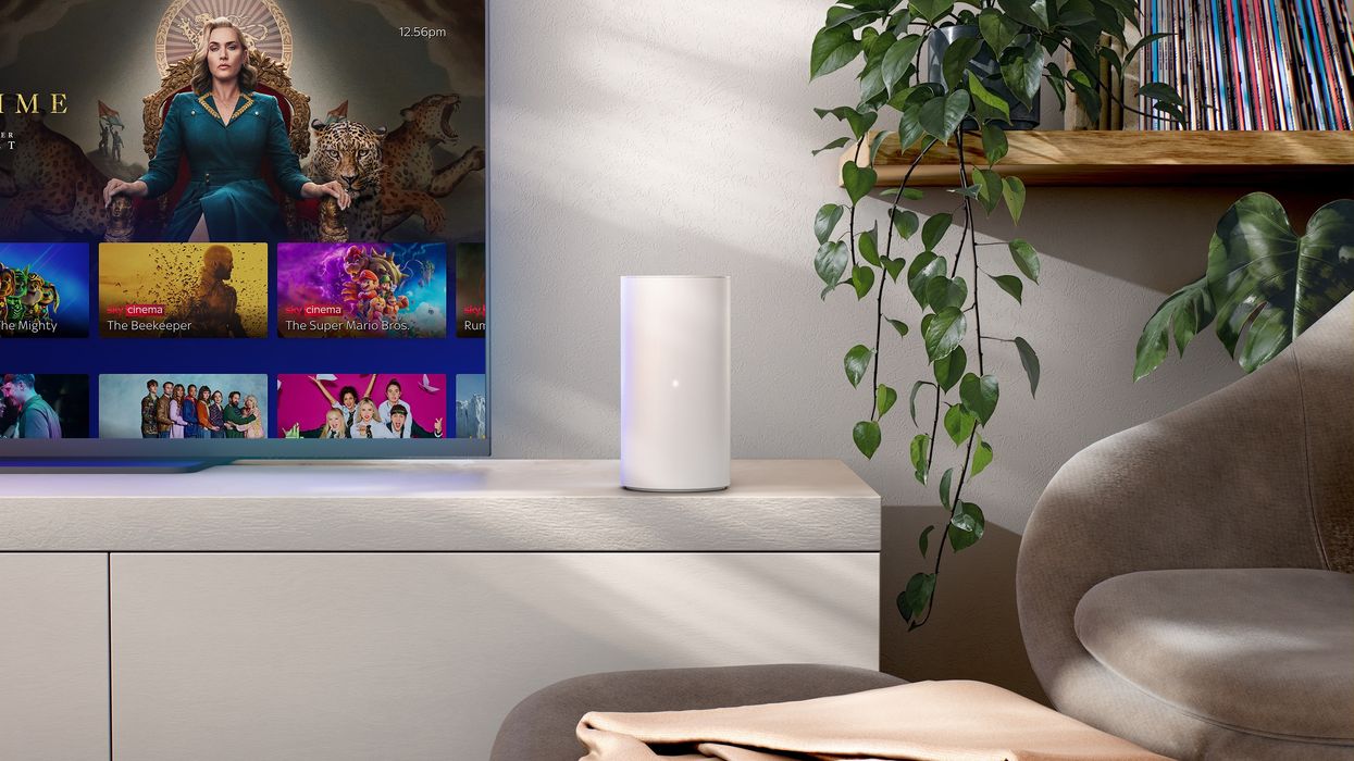 Sky Gigafast+ hub pictured on a media unit with a Sky Glass television beside it