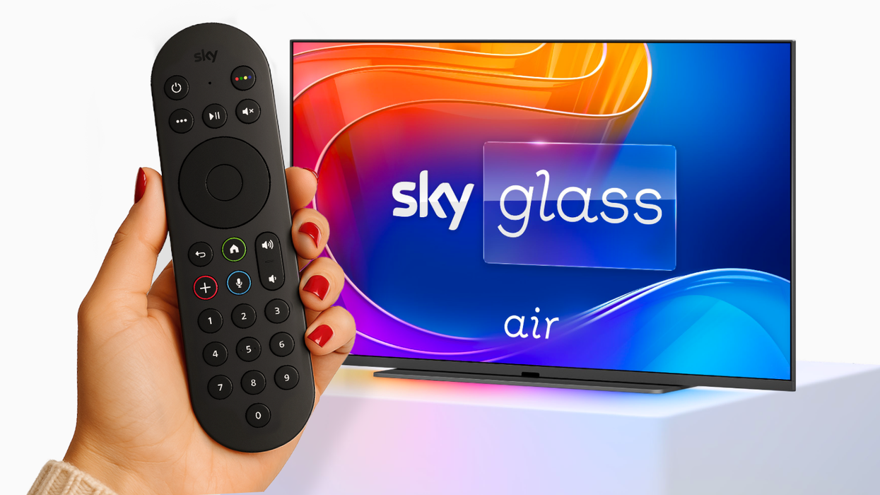 sky glass air television pictured on a plinth with a hand holding a remote in the foreground