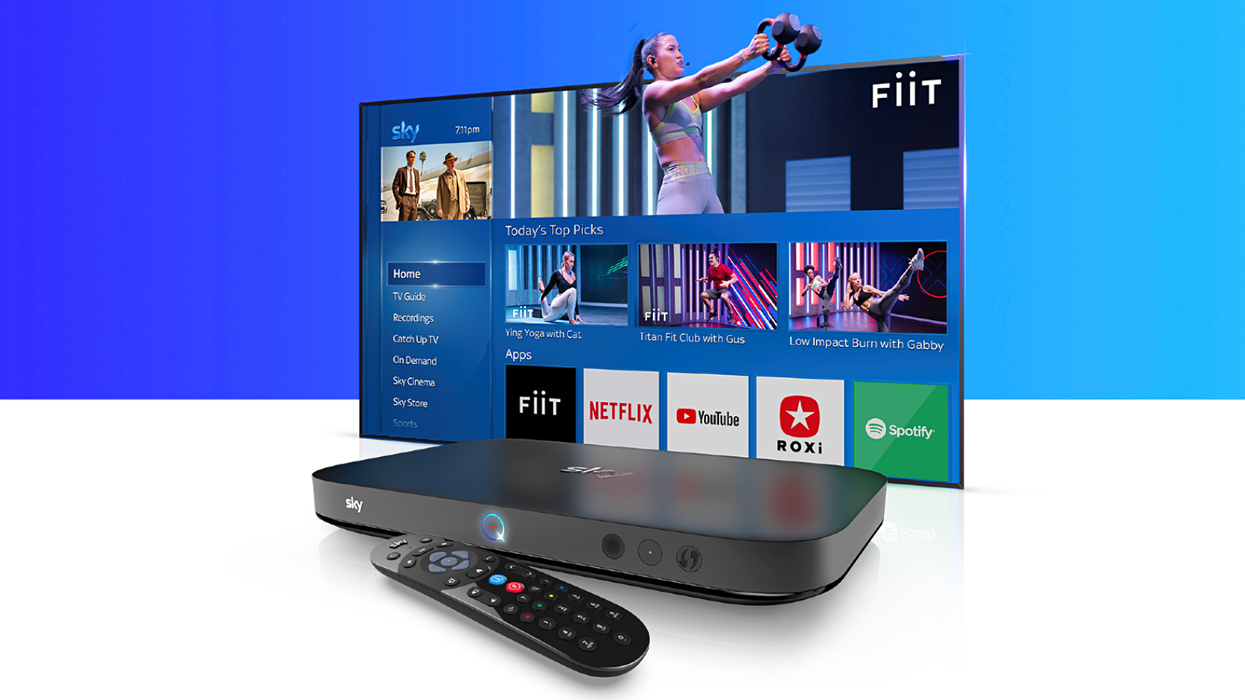 Sky Q box with flatscreen television in the background with channels and TV Guide shown