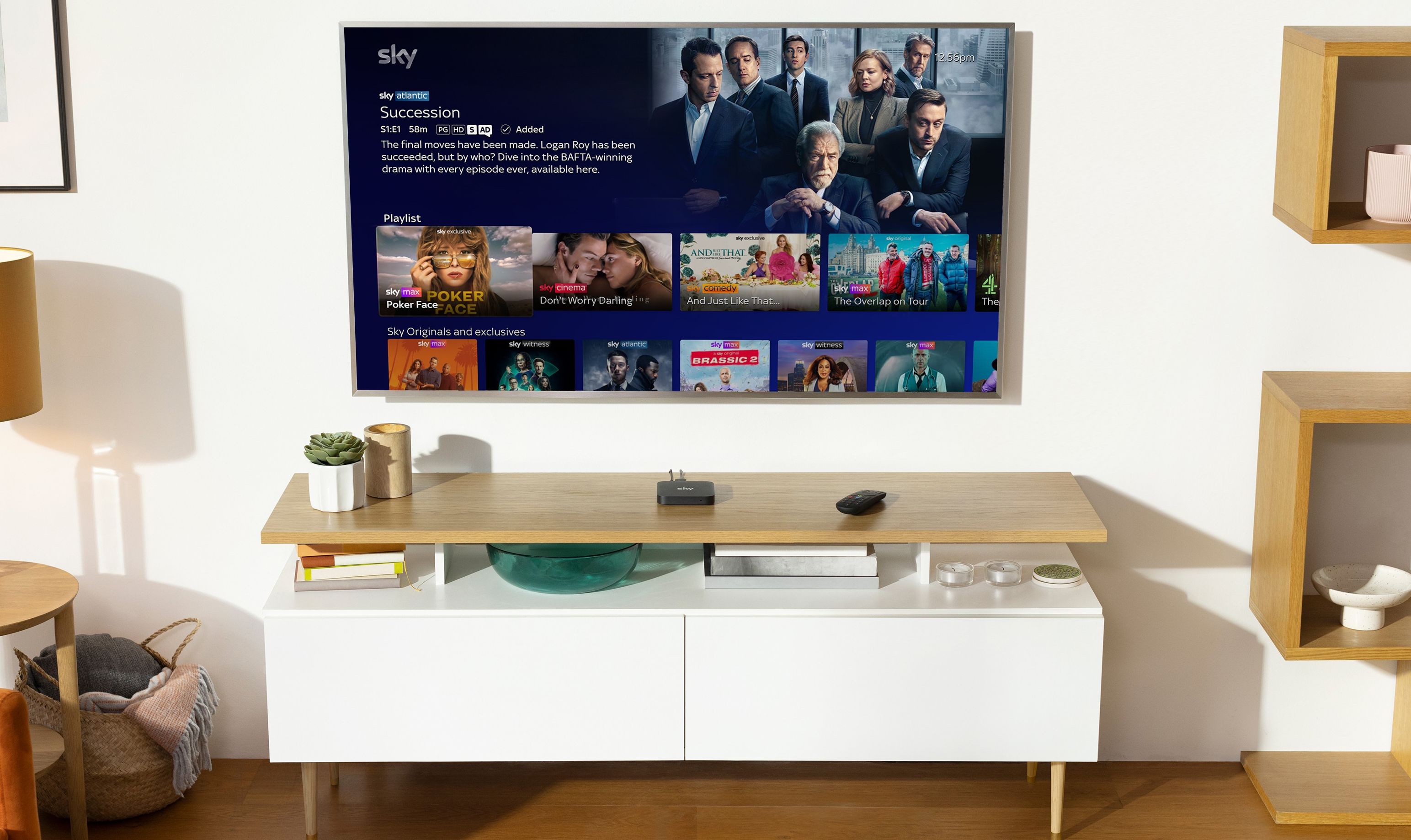 sky stream box is pictured on a media unit with a flatscreen tv showing succession