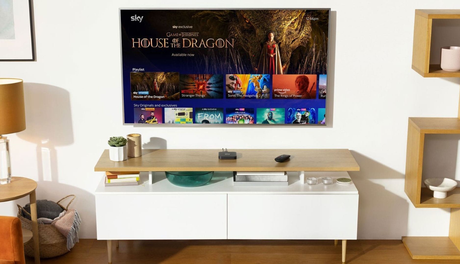 sky stream box on a table with a television in the background showing house of the dragon