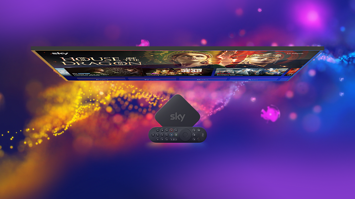 sky stream box with remote on-top with a flatscreen television showing house of the dragon behind it