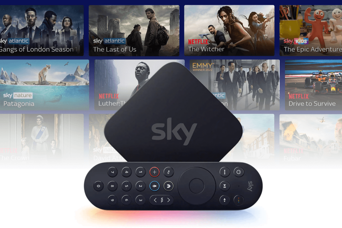 Sky Stream box with the remote control on its side with a selection of shows in the background