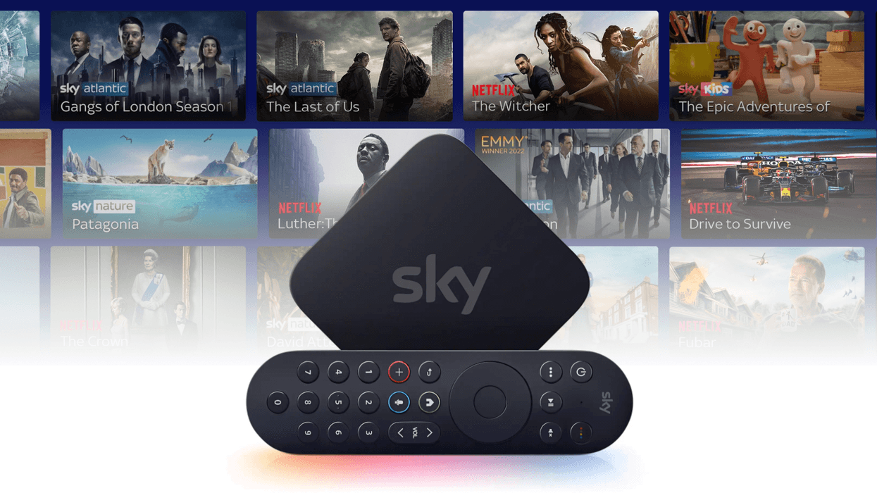 Sky Stream box with the remote control on its side with a selection of shows in the background
