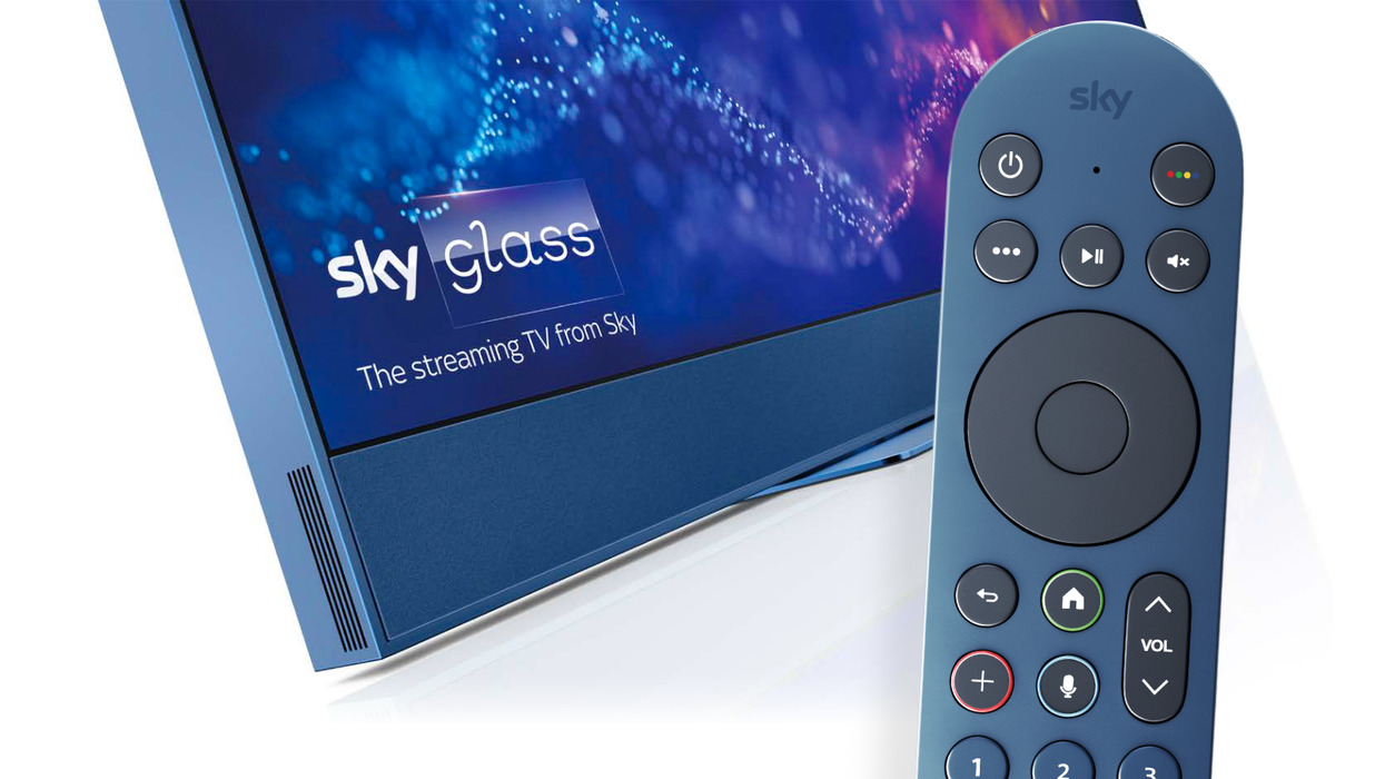 Sky TV remote control in the foreground with a blue sky glass in the background