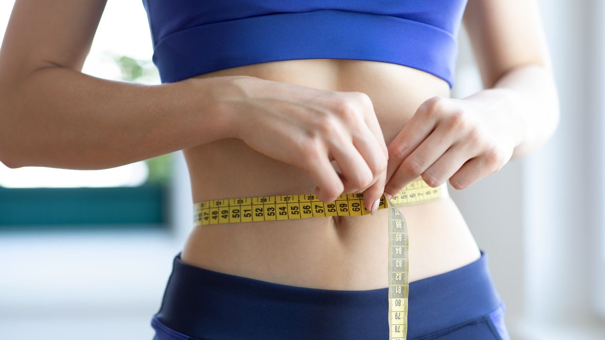 Slim woman measuring her waist