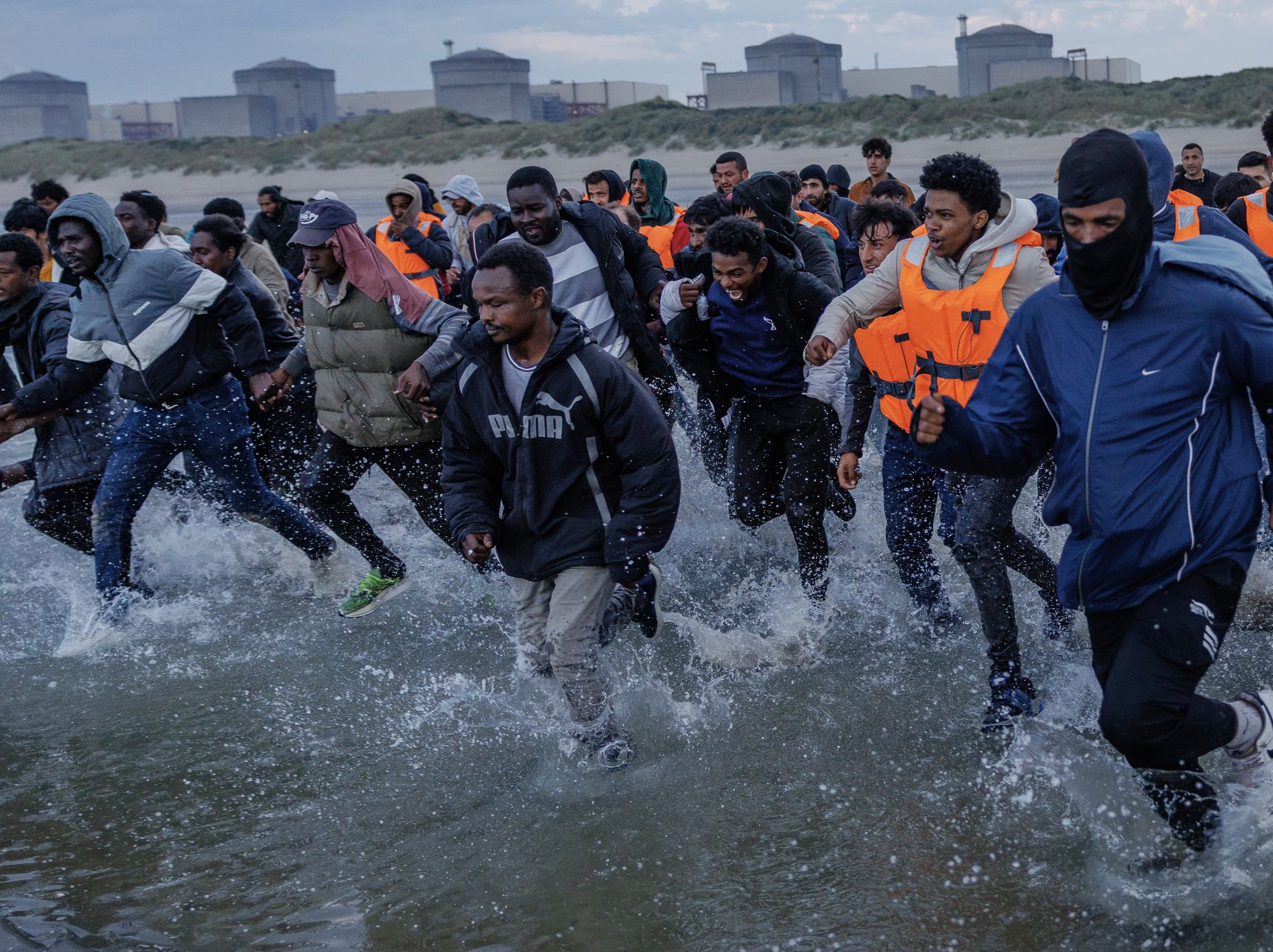 Small boat migrants on beach