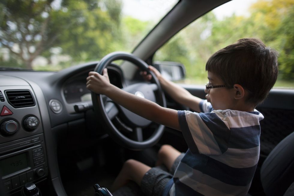 Small child behind the wheel of a car