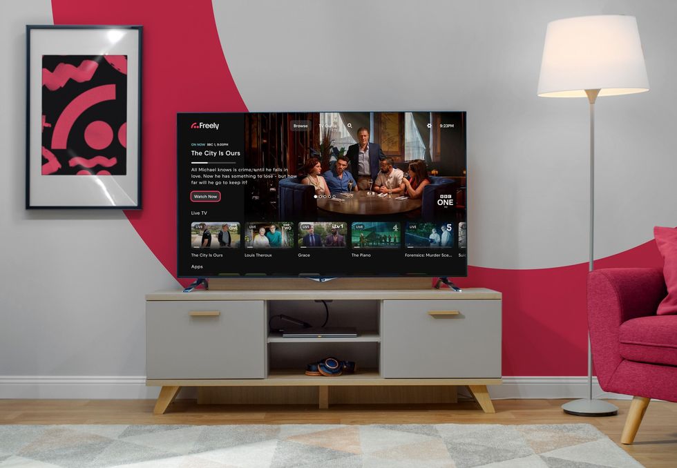 Smart TV in a living room with the Freely logo in the background with the Never Miss feature shown on-screen