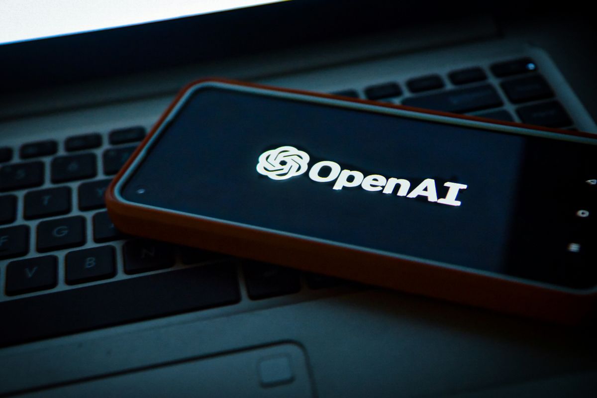 smartphone with the OpenAi logo on screen laying on a keyboard