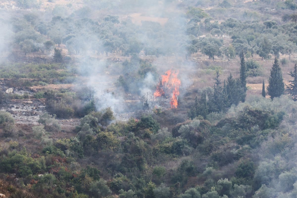 Smoke and fire are seen after Israeli shelling in the village of Dhayra, near the border with Israel, in southern Lebanon