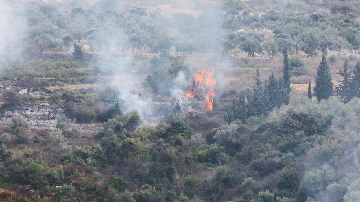 Smoke and fire are seen after Israeli shelling in the village of Dhayra, near the border with Israel, in southern Lebanon