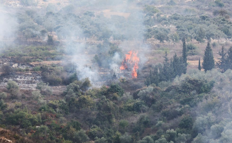 Smoke and fire are seen after Israeli shelling in the village of Dhayra, near the border with Israel, in southern Lebanon
