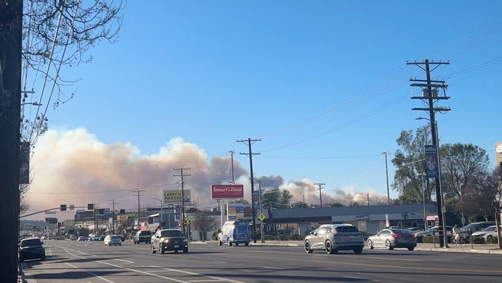 Smoke billows over Woodland Hills, where the Kenneth Fire is raging