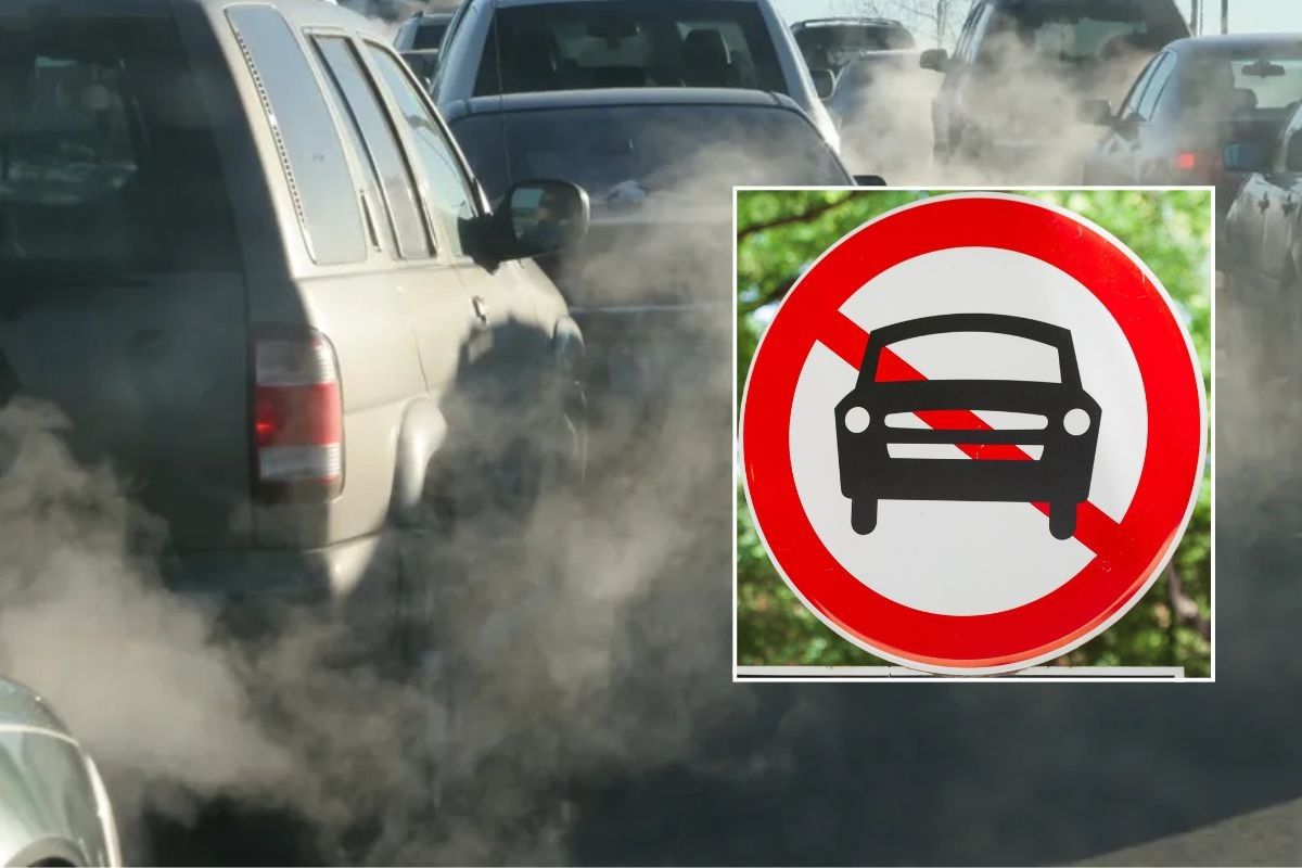 Smoke filled road and a car ban sign
