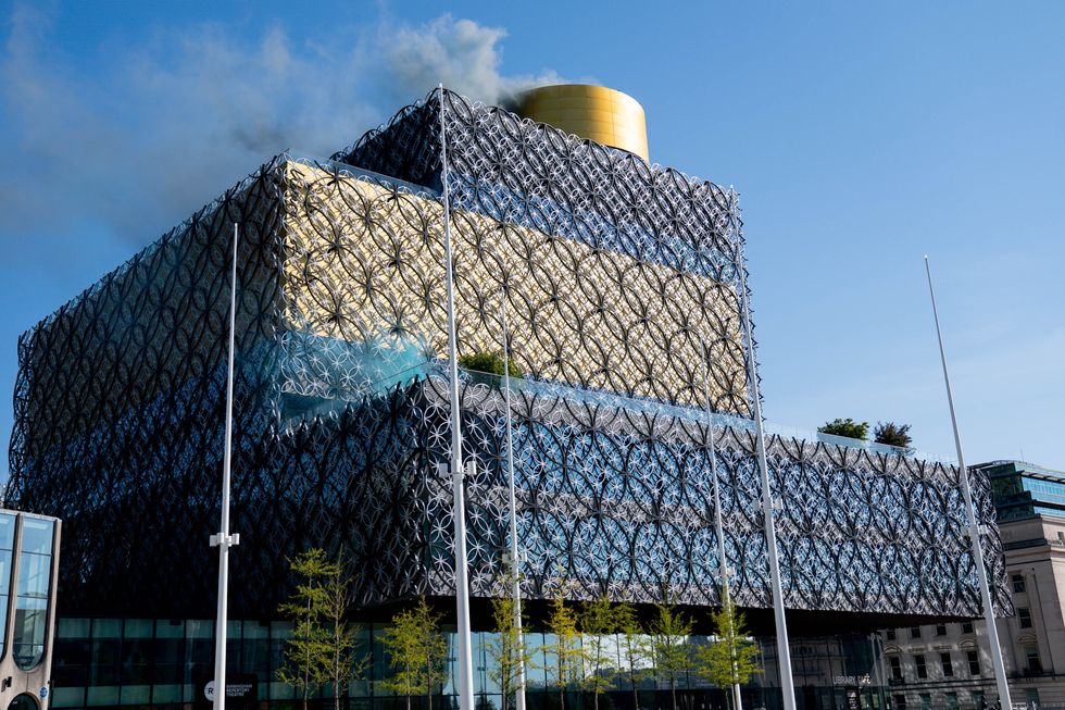 Smoke is released from Birmingham Library to represent nitrogen oxides saved by the clean air zone launched in Birmingham.