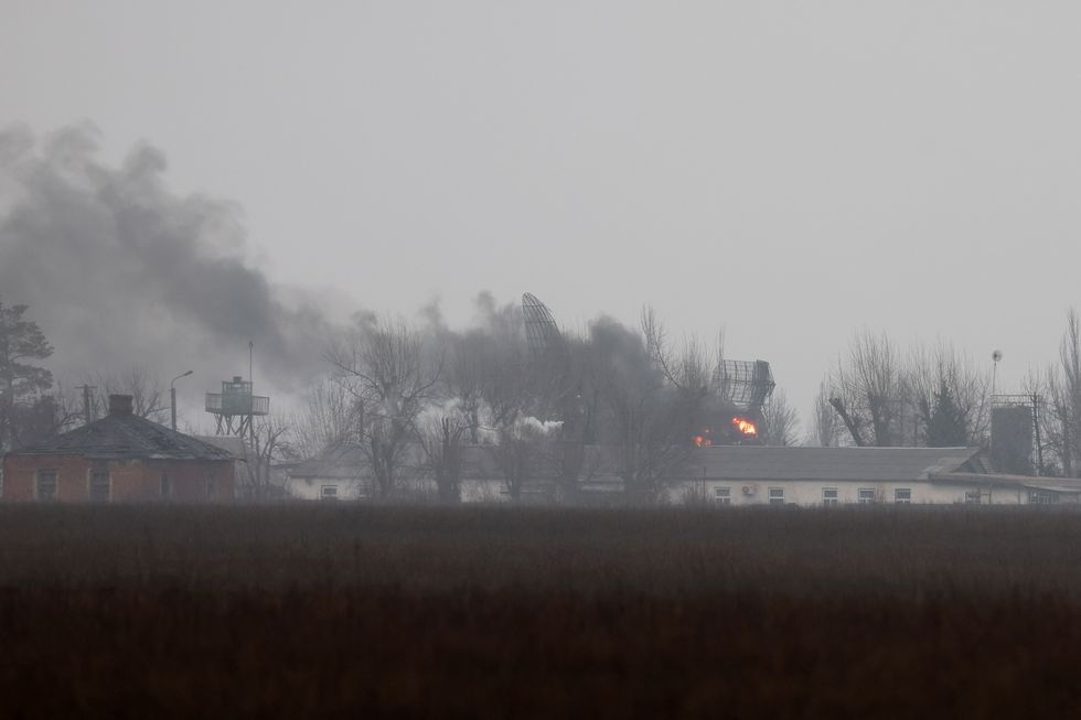 Smoke is seen coming out of a military installation near the airport, after Russian President Vladimir Putin authorised a military operation in eastern Ukraine, in Mariupol, February 24, 2022. REUTERS/Carlos Barria