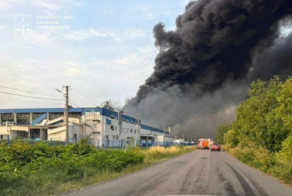 Smoke plumes out of the US-owned business's factory following the strikes