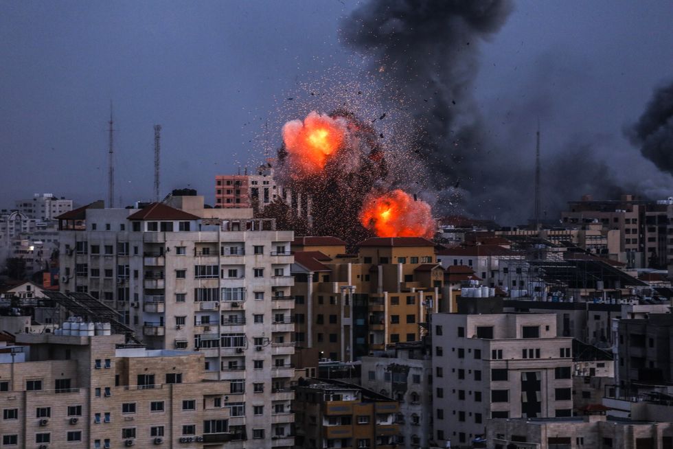Smoke rises and ball of fire over a buildings in Gaza City