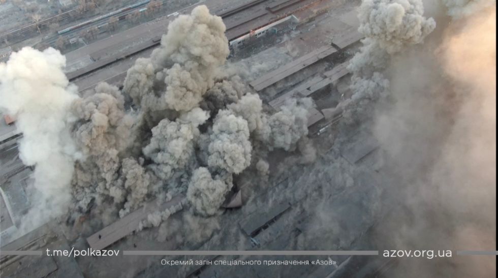 Smoke rises around an industrial compound after multiple explosions, amid the Russian invasion of Ukraine, in Mariupol, in this screengrab from a video released on March 22, 2022. AZOV/Handout via REUTERS