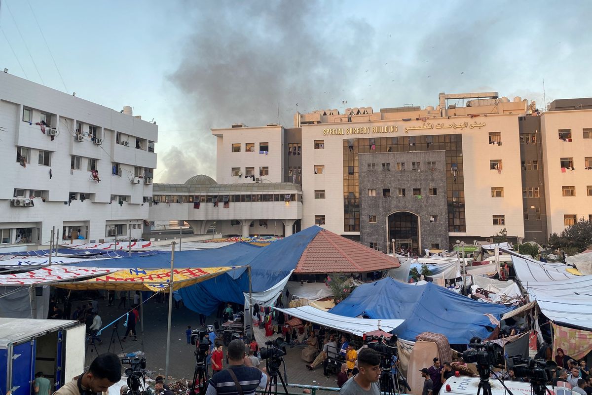 Smoke rises as displaced Palestinians take shelter at Al Shifa hospital on November 8