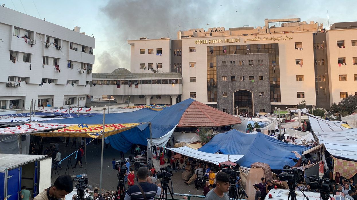Smoke rises as displaced Palestinians take shelter at Al Shifa hospital on November 8