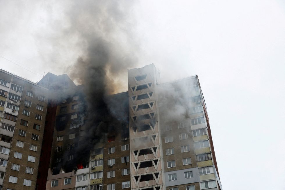 Smoke rises from a burning building damaged during a Russian missile strike