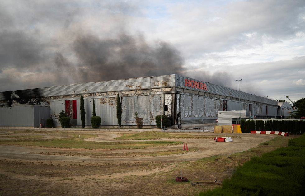 Smoke rises from a fire at a motorcycle production plant belonging to Japan's Honda in Santa Perpetua de Mogoda, near Barcelona, Spain