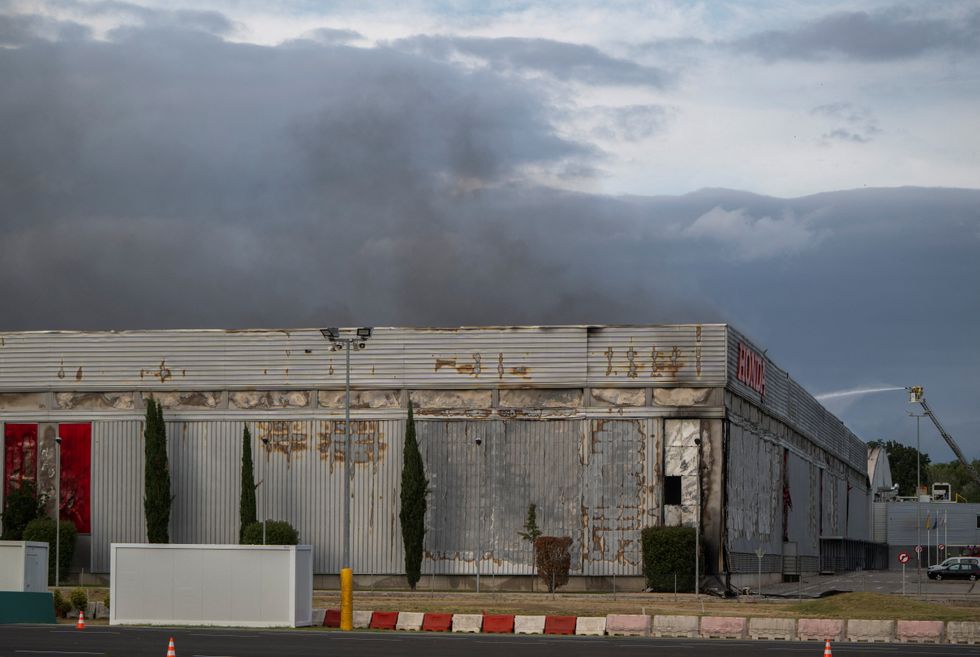 Smoke rises from a fire at a motorcycle production plant belonging to Japan's Honda in Santa Perpetua de Mogoda, near Barcelona, Spain