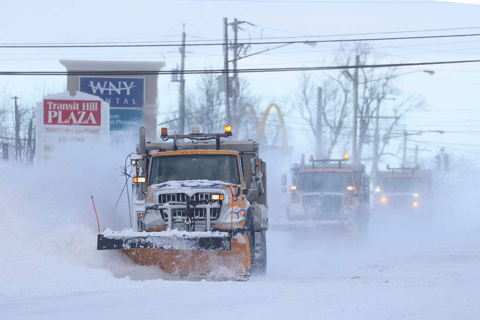 Snow plows clear the roads following a winter storm that hit the Buffalo region in Lancaster, New York, U.S., December 25, 2022. REUTERS/Brendan McDermid