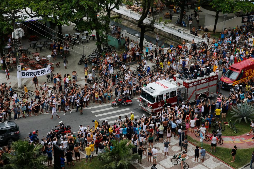 Soccer Football - Death of Brazilian soccer legend Pele - Santos, Brazil - January 3, 2023 General view of fans as the casket of Brazilian soccer legend Pele is transported by the fire department, from his former club Santos' Vila Belmiro stadium REUTERS/Diego Vara