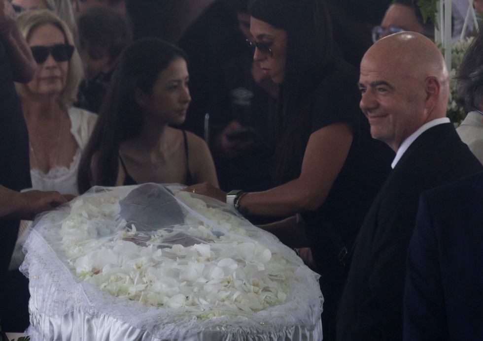 Soccer Football - Death of Brazilian soccer legend Pele - Vila Belmiro Stadium, Santos, Brazil - January 2, 2023 SENSITIVE MATERIAL. THIS IMAGE MAY OFFEND OR DISTURB, FIFA president Gianni Infantino is pictured as the body of Brazilian soccer legend Pele is seen in his casket, as he lies in state on the pitch of his former club Santos' Vila Belmiro stadium REUTERS/Ricardo Moraes