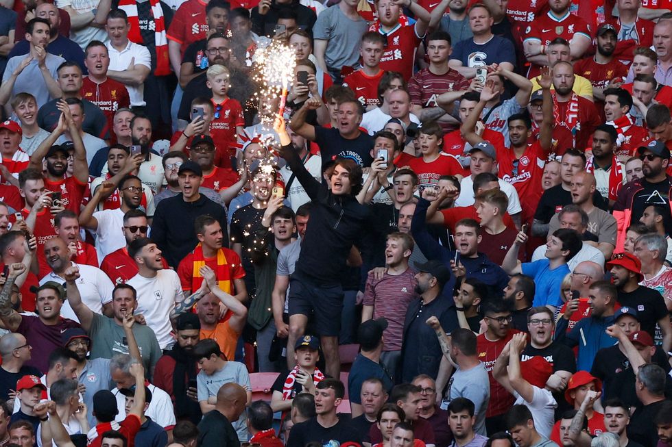 Soccer Football - FA Cup - Final - Chelsea v Liverpool - Wembley Stadium, London, Britain - May 14, 2022 A Liverpool fan holds a flare in the stands Action Images via Reuters/Peter Cziborra
