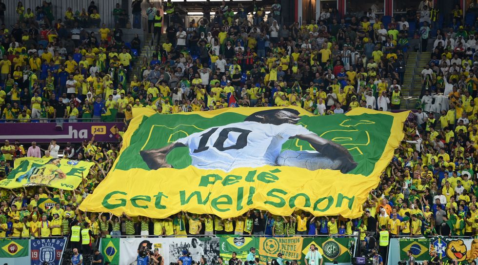 Soccer Football - FIFA World Cup Qatar 2022 - Round of 16 - Brazil v South Korea - Stadium 974, Doha, Qatar - December 5, 2022 Fans inside the stadium hold up a banner of former Brazil player Pele with the message get well soon REUTERS/Annegret Hilse
