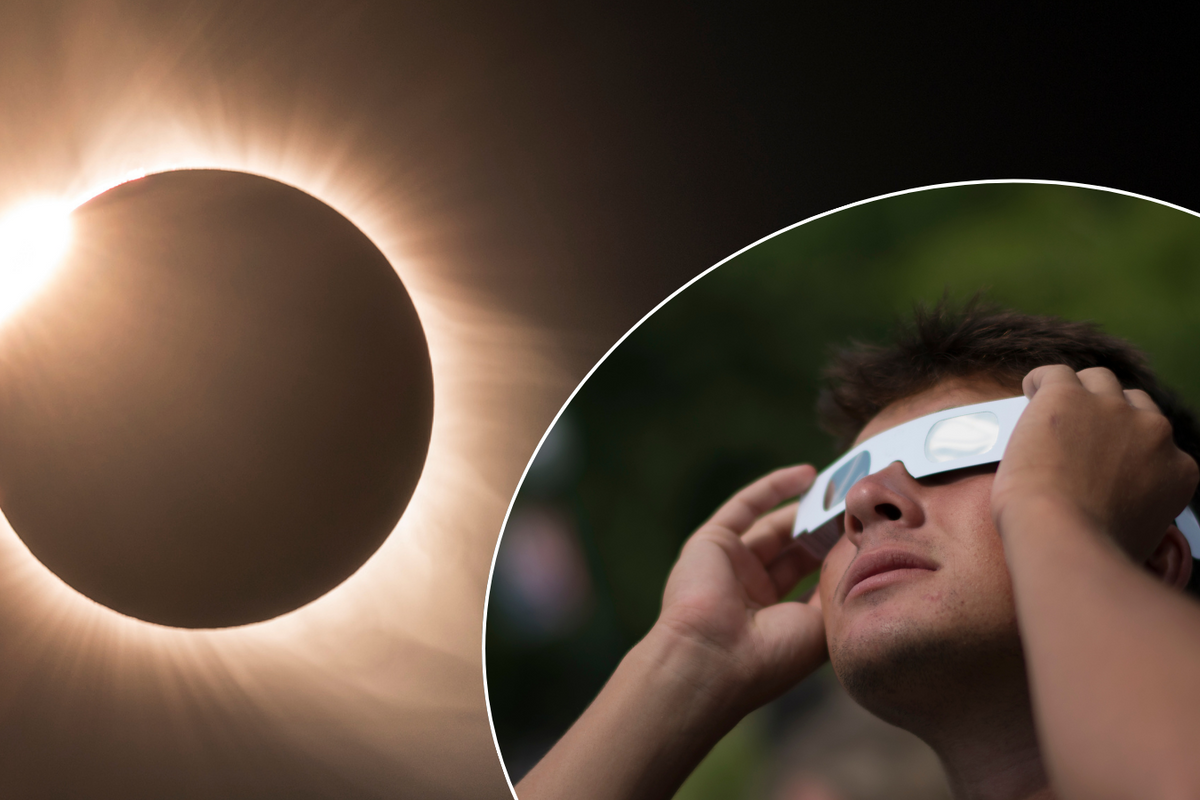 Solar eclipse/man observing it with glasses