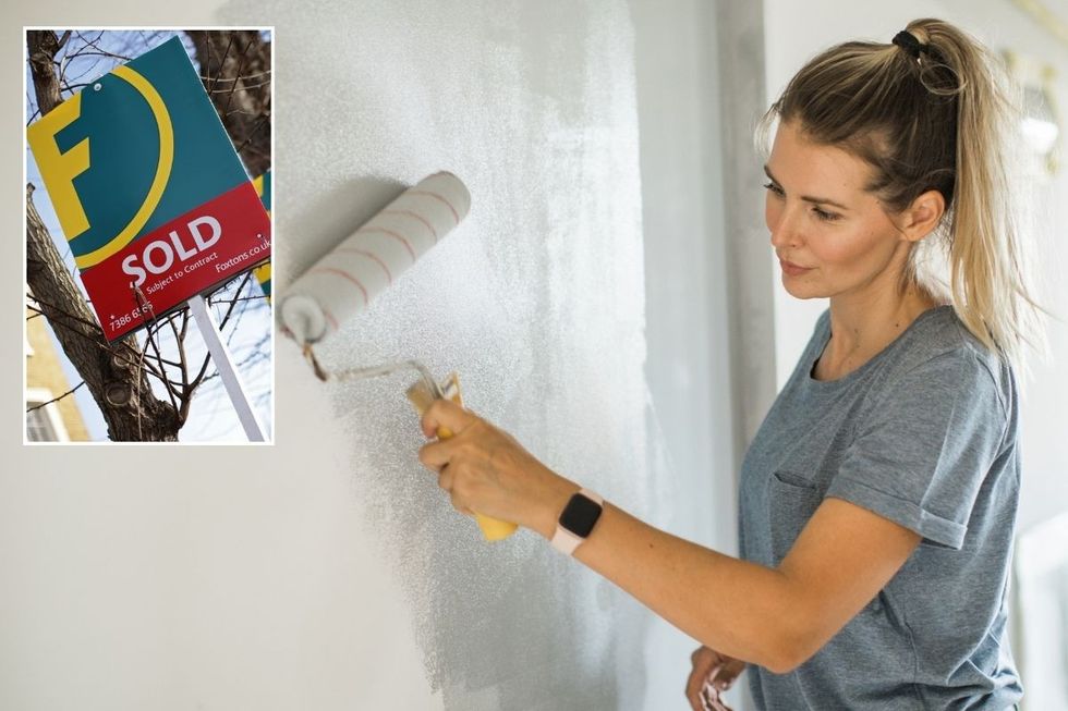 Sold sign / Woman painting wall grey